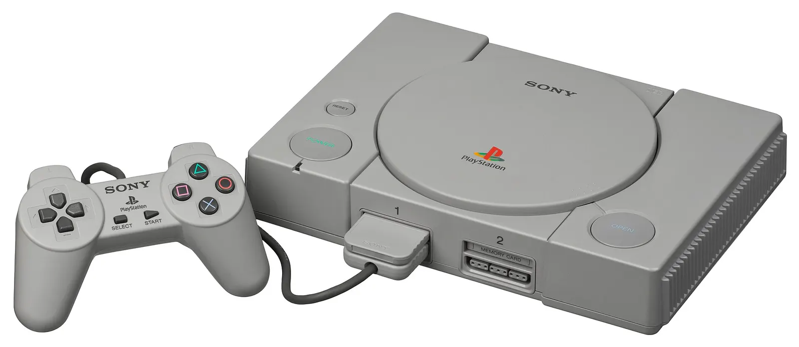 Szare PlayStation SCPH-1000 z oryginalnym kontrolerem bez drążków analogowych.